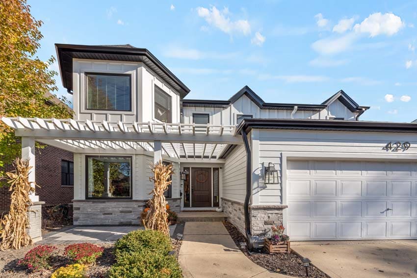 Elmhurst, Illlinois, exterior of home with wood pergola and white siding 