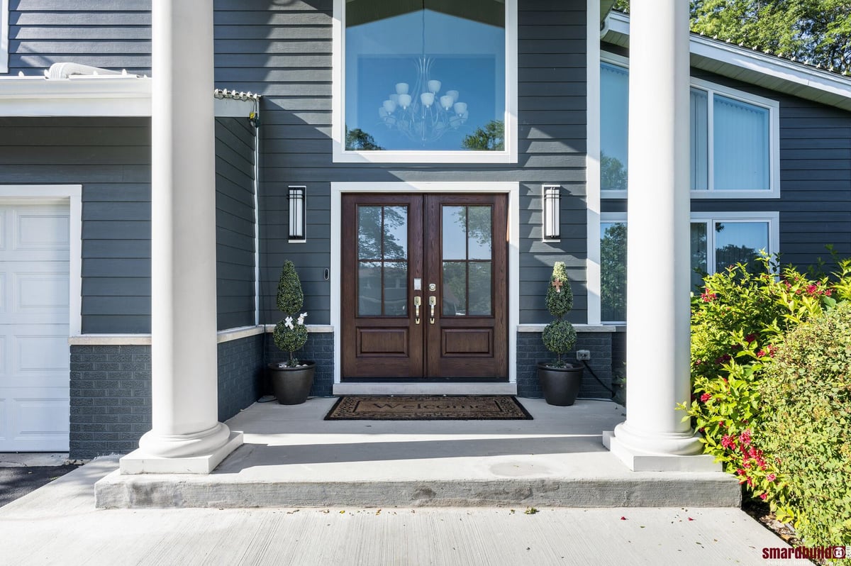 exterior view of home with large window and wood doors